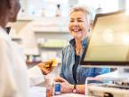 Customer speaking to pharmacist at prescription counter